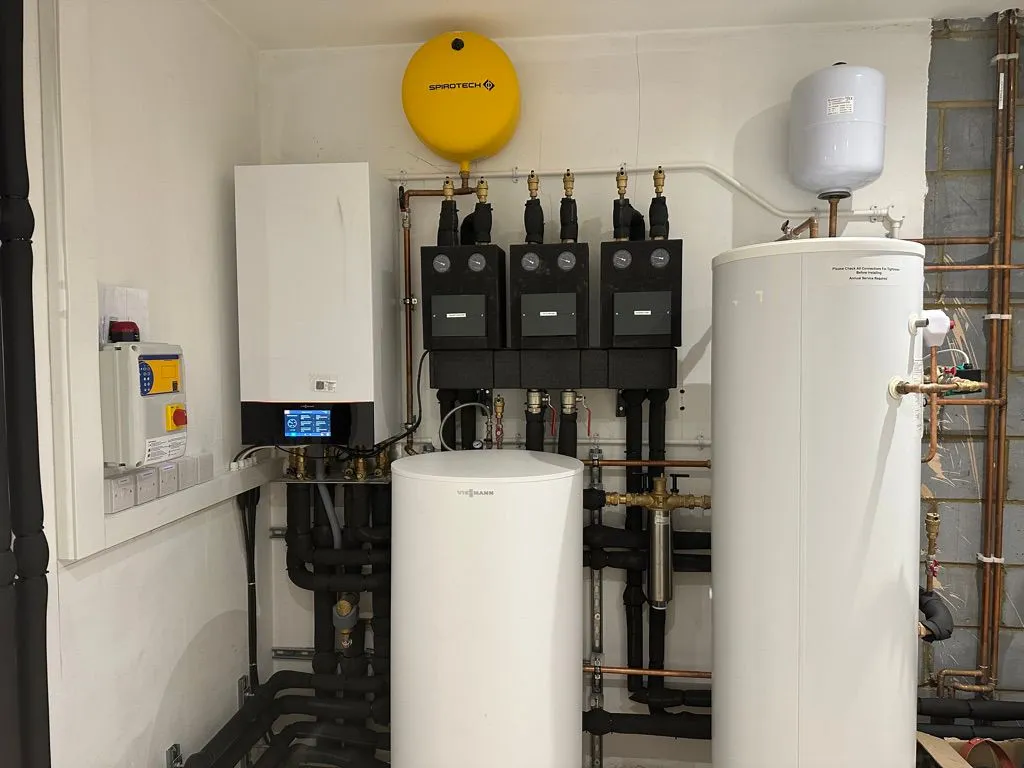 Boiler, Spirotech filter, hot water cylinders and heating manifold installed in a plant room