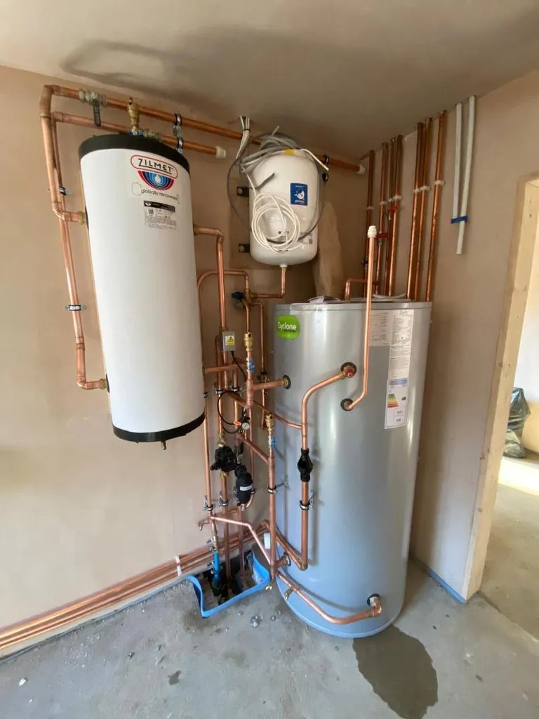 Unvented hot water cylinder and thermal store with copper pipework during installation