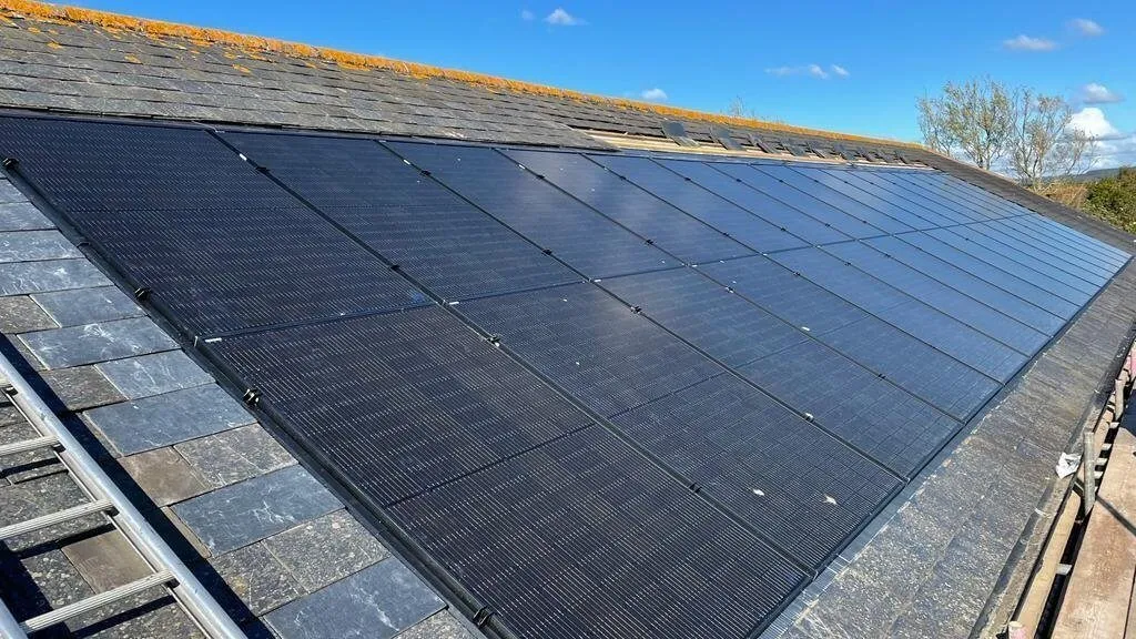 Solar panel array installed on a slate roof in a historic Carters project