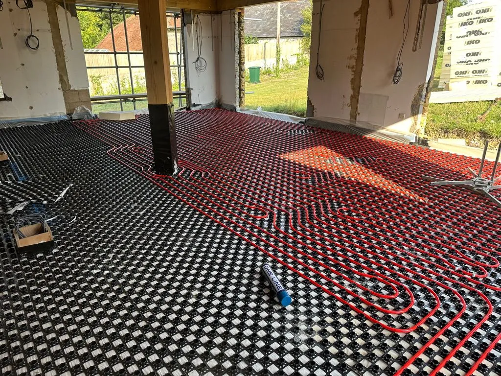 Underfloor heating pipe laid in castellated panels on a renovation project
