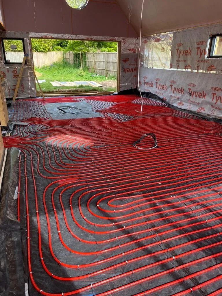 Underfloor heating pipework laid across a room during a new build installation