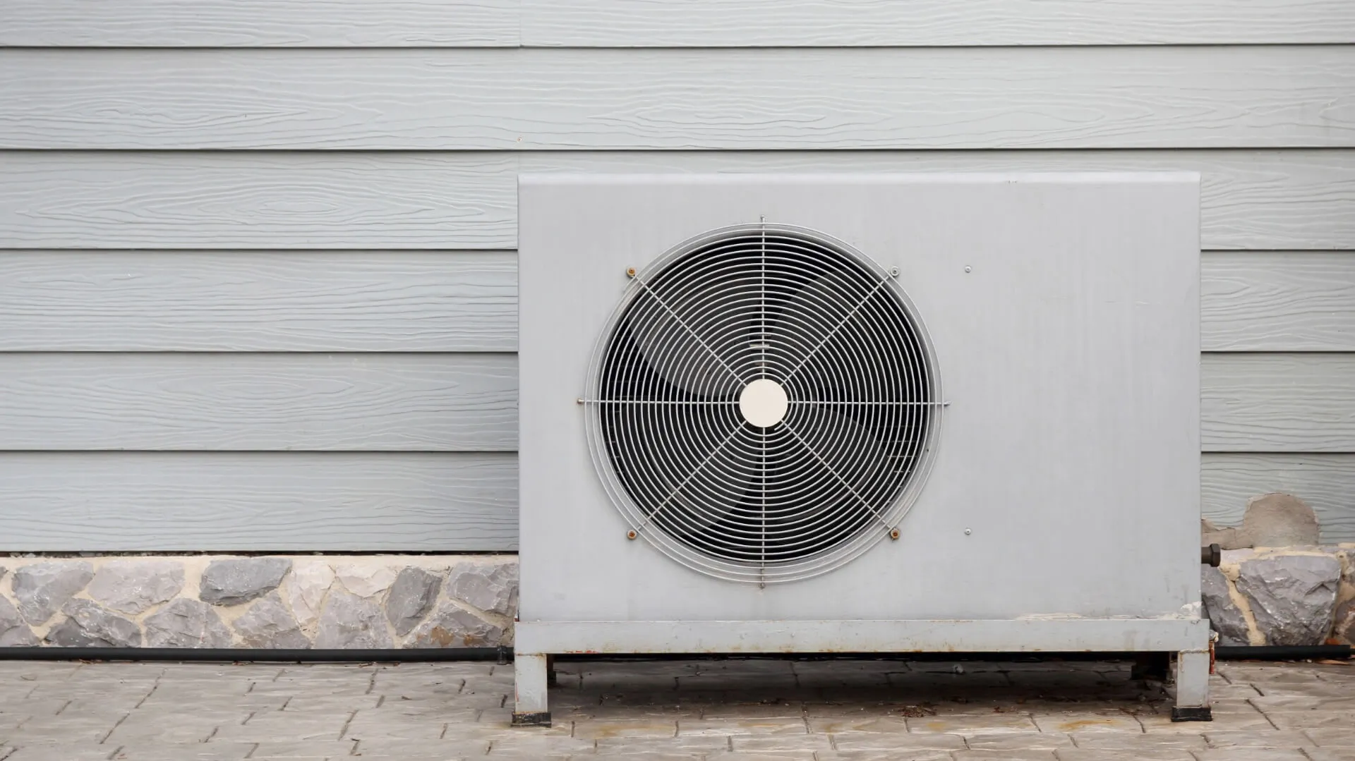 Air source heat pump installed beside a home